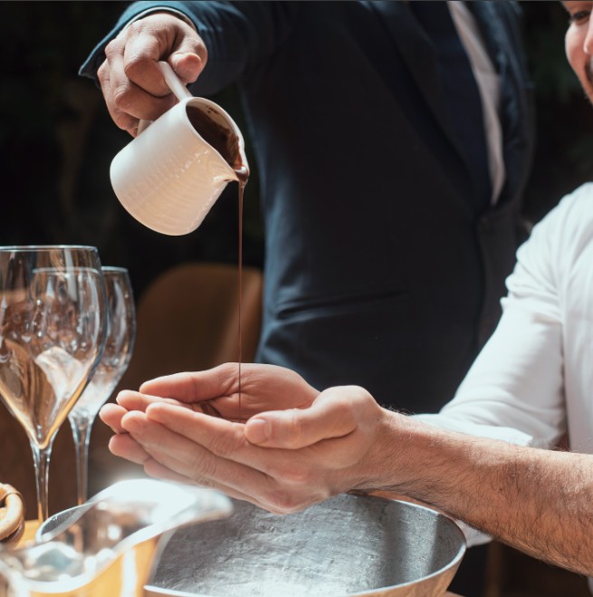 pouring chocolate into hands at restaurant